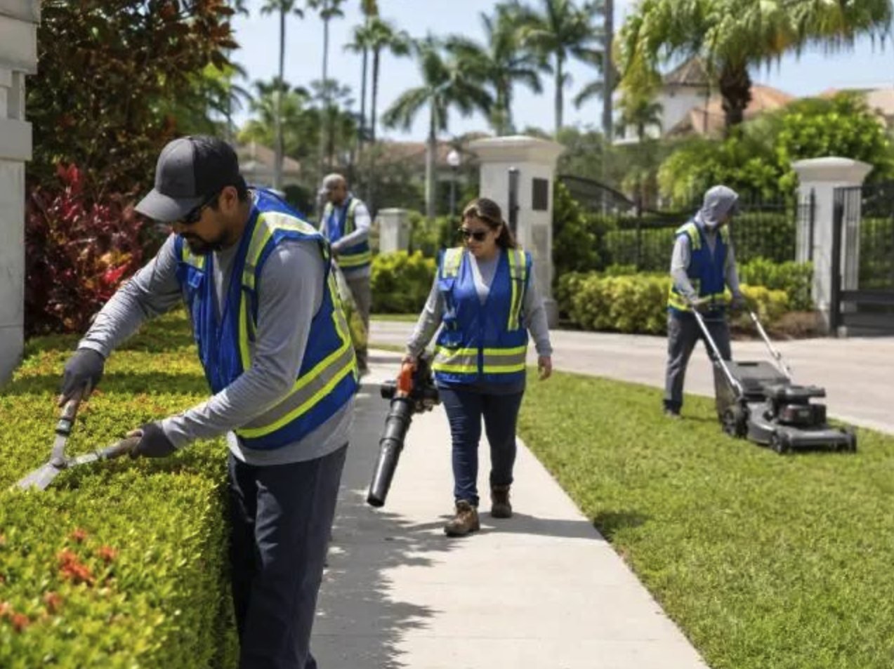 Eco Sparkle grounds crew edging hedges, blowing walkways and mowing